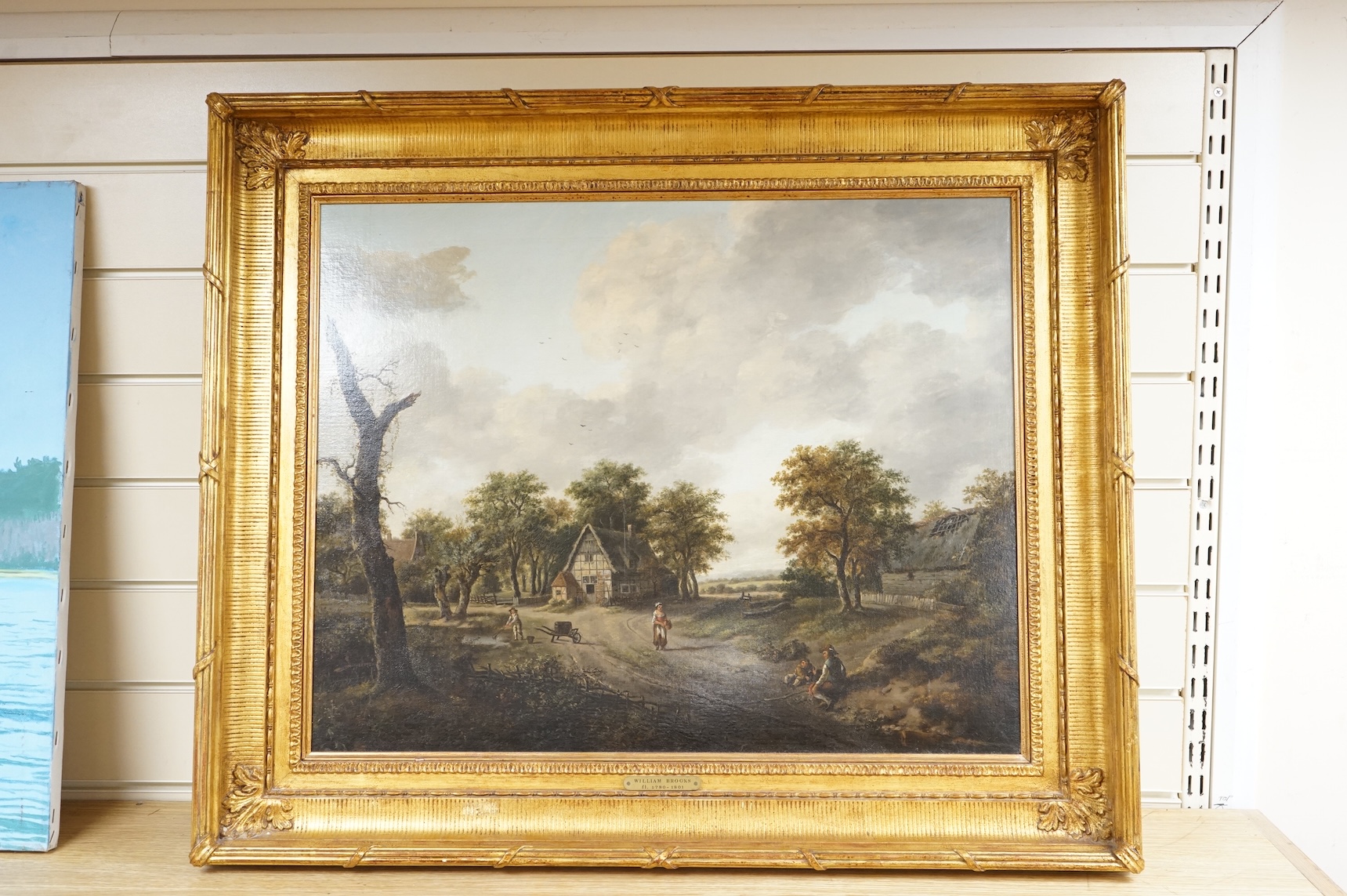 William Brooks (fl.1780-1801), Village scene with figures, unsigned, oil on canvas, 49 x 62cm, applied plaque to the ornate gilt frame